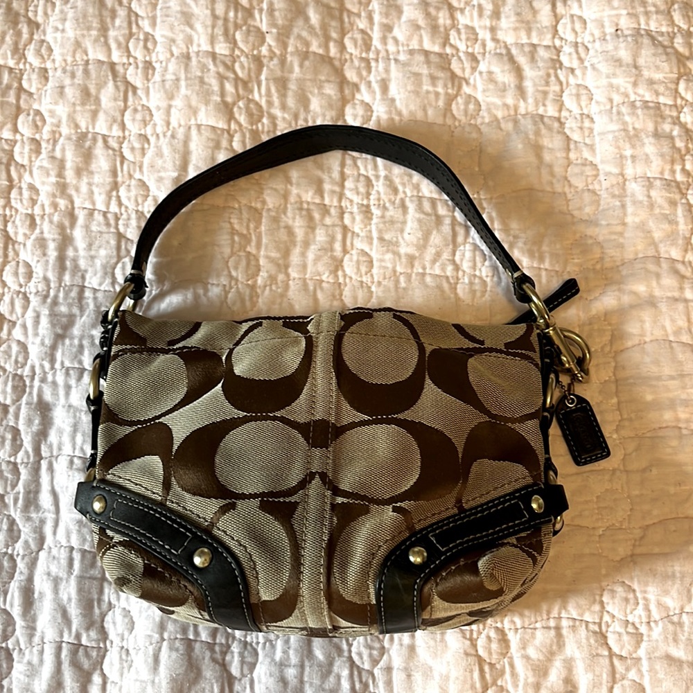 Coach Canvas Mini Bag with Signatura Logo “C”s. Leather Rivited Straps Accents.